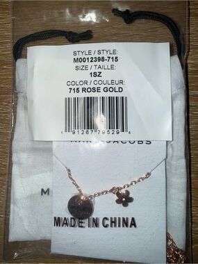 Marc Jacobs MJ Coin Daisy Charm Pendant Necklace in rose gold.